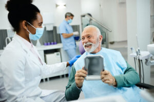 dental professional explaining the benefits of choosing dental implants over other dental solutions to a patient