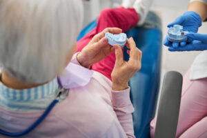 dental professional showing a prototype to patient while explaining the process for getting dentures