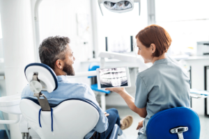 dental professional discussing with a patient how often should you get an oral cancer screening