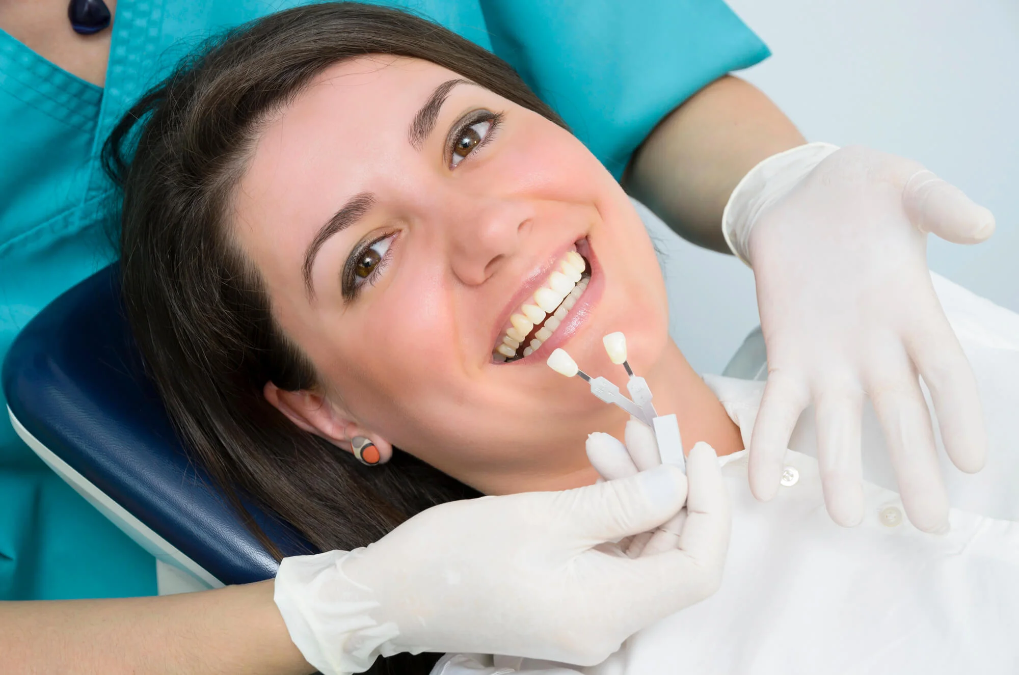 Patient comparing tooth shades smile makeover in Durham