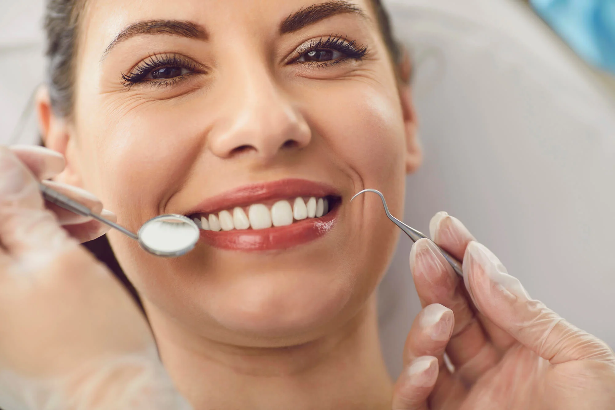 Smiling patient after dental treatment repair decayed teeth