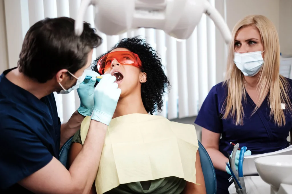 Patient receiving dental exam for tooth restoration options